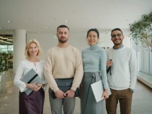 Diverse group of professionals standing together indoors.