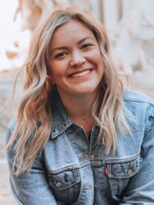 woman smiling wearing denim jacket