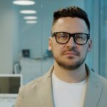 Man with glasses in a modern office setting
