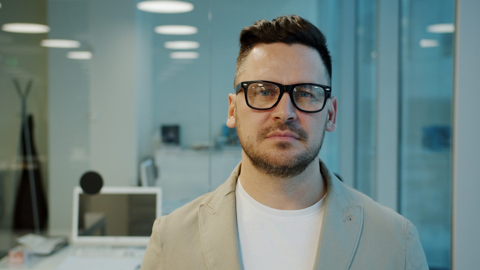 Man with glasses in a modern office setting